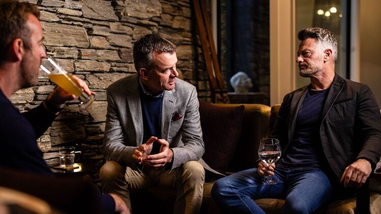 Boys having drinks: Three casually chic businessmen enjoying a drink in the lounge of boutique accommodation, Queenstown Park Boutique Hotel